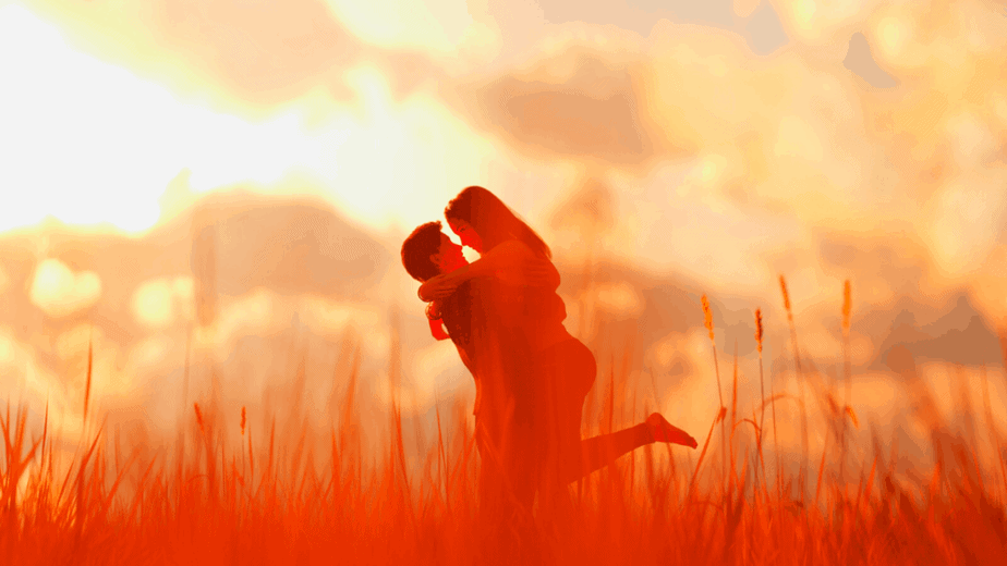 Decorative image of a couple in love, embracing in a wheat field while the sun sets. They know how to attract love.