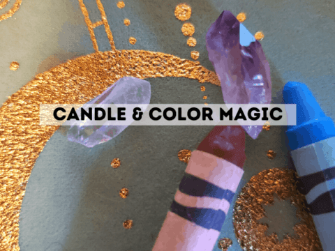 A brown crayon, blue crayon, and two crystals on an occult witch cloth