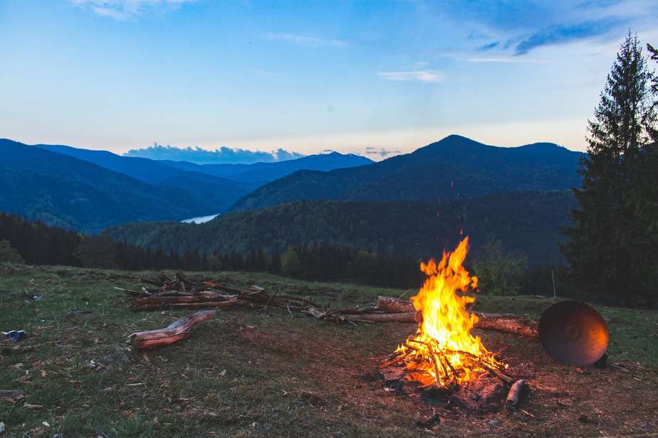 bonfire surrounded with green grass field
