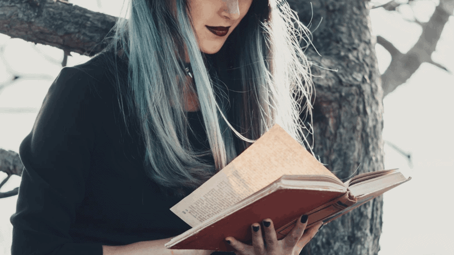 Decorative image of a witch reading a book