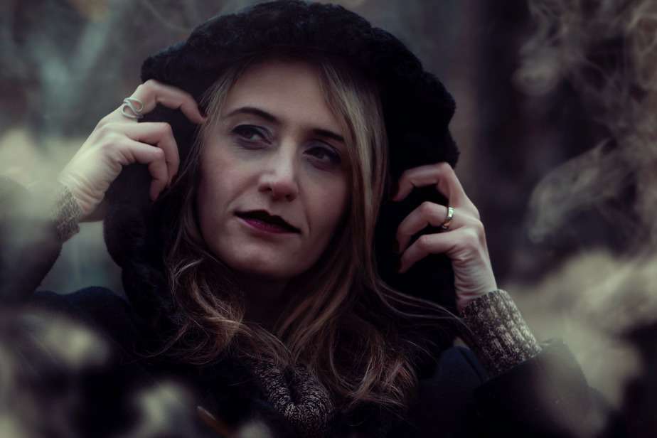 close up photography of woman wearing black hooded jacket