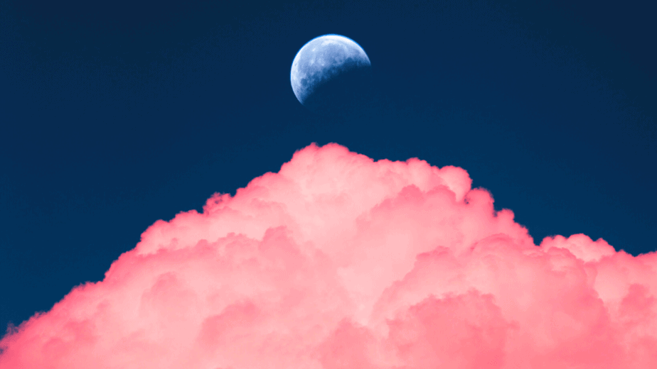Decorative image of the moon behind pink clouds for moon magick