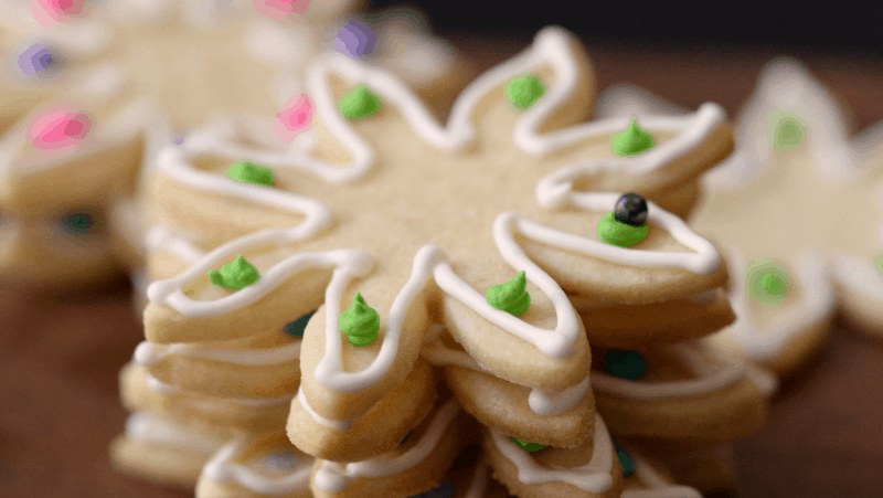 Sugar cookies decorated with icing and bead sprinkles.