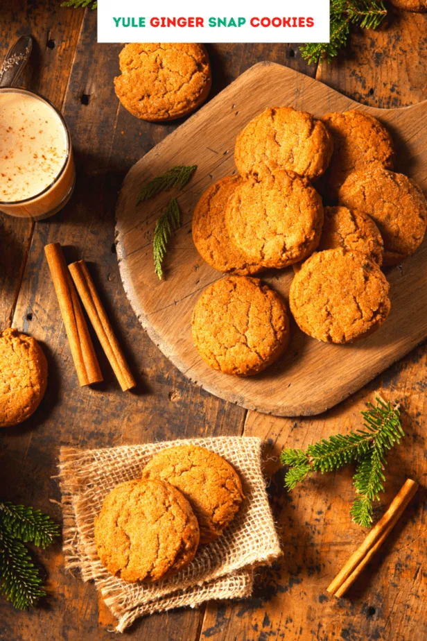 Golden gingersnap cookies with cinnamon, pine needles, a latte, and other rustic decor
