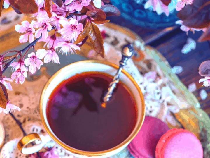 Self Love Hibiscus Tea with flowers and cookies on an ornate plate
