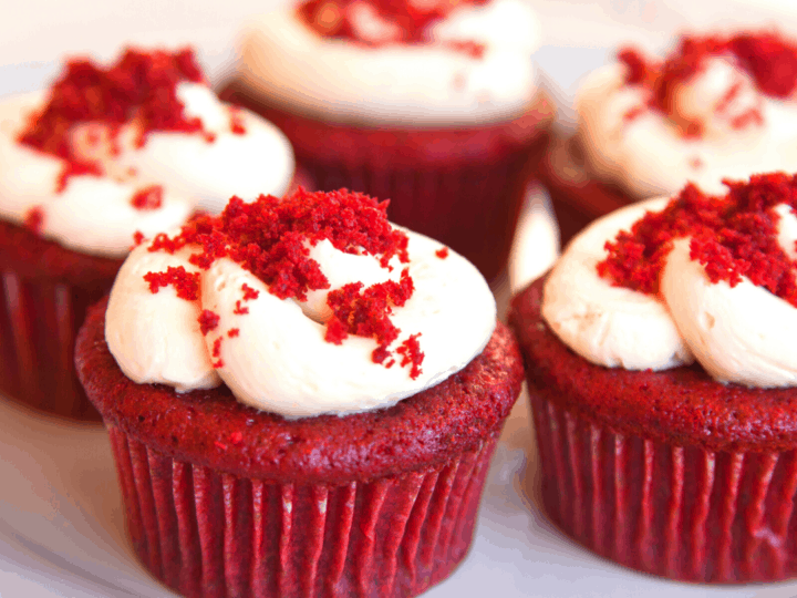 Red velvet cupcakes with cream cheese frosting and crumbles on top