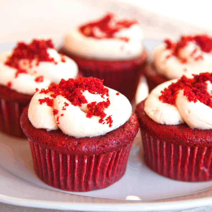 Red velvet cupcakes with cream cheese frosting and crumbles on top