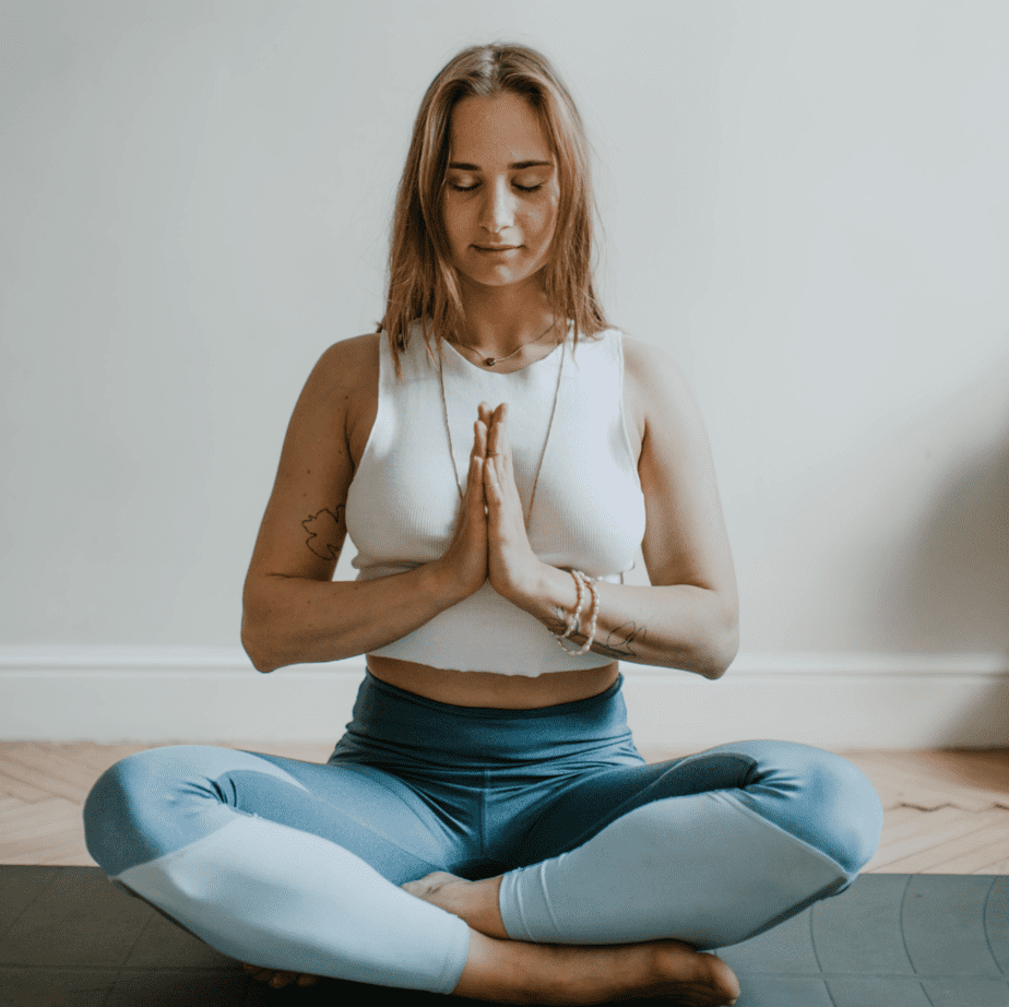 A woman meditating to balance her root chakra