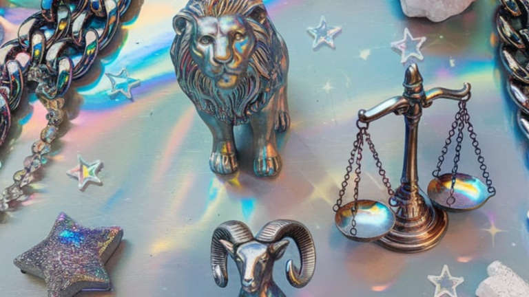 A playful holographic flat lay featuring a lion for Leo, a ram for Aries, and scales for Libra, crafted from metallic materials. The scene is framed with chunky iridescent chains, crystals, and star confetti, evoking a futuristic Y2K zodiac theme.