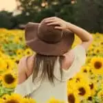 photo of woman in a sunflower field