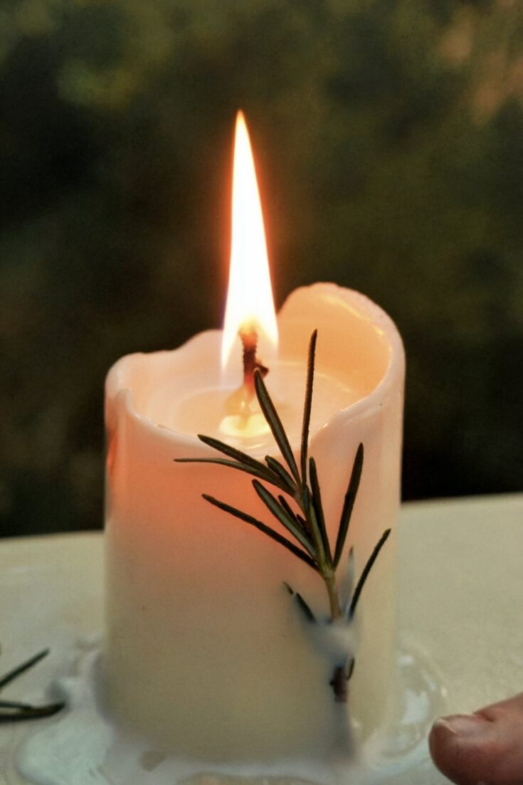 Decorative Image | How to Bless White Candles for Yule Using Grocery Store Materials | White candles show up at grocery stores for a dollar. Unscented tapers, plain pillars, bags of tea lights. By the time you take one home and prepare it for Yule, that ordinary wax column holds something specific: your intention for getting through winter, pressed into the wax and released slowly as it burns.