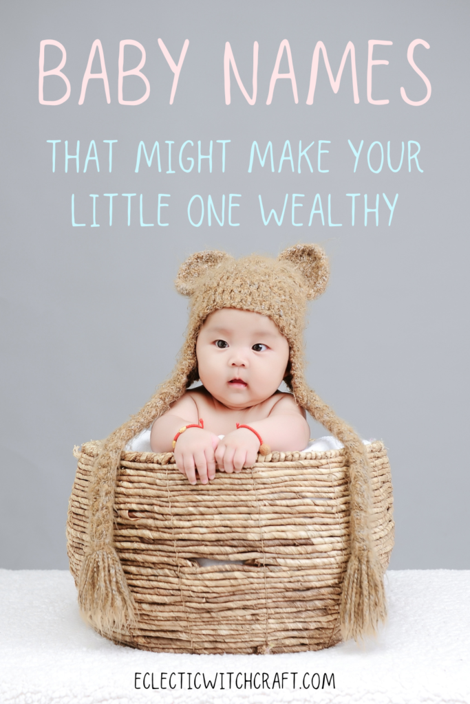 baby in wicker basket wearing a knitted cap with bear ears and long tassels in gray room, money correspondence magick and baby names, wealth and prosperity