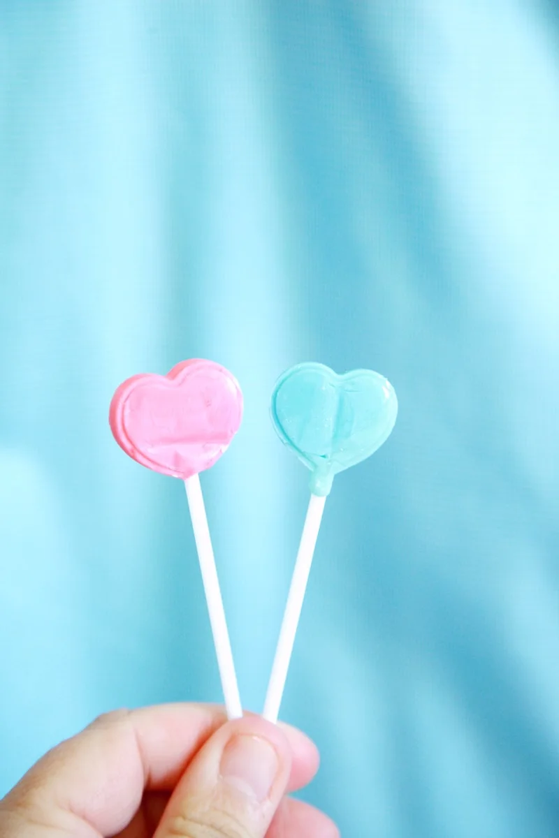 pink heart lollipop on white textile