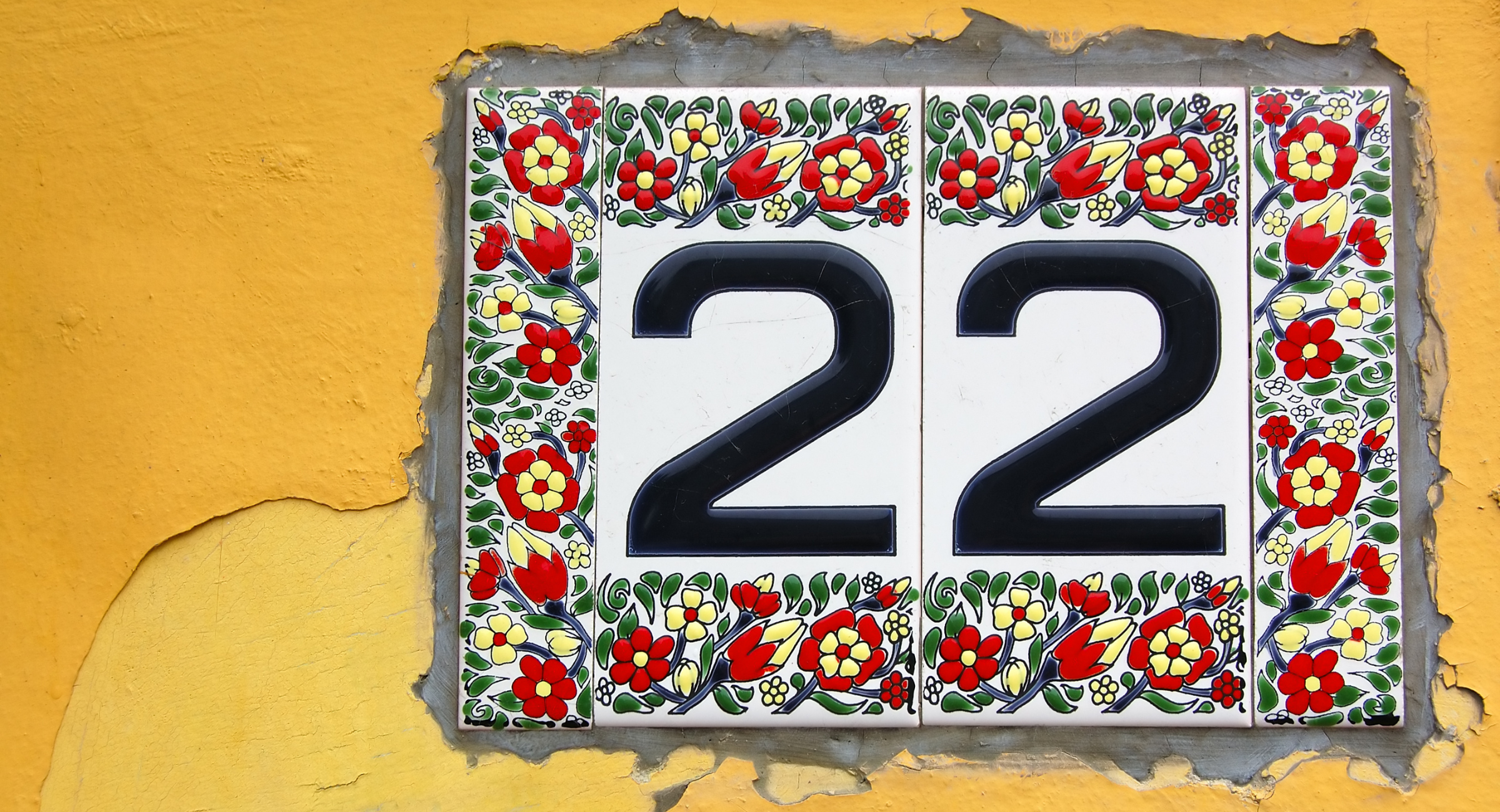 Tile with flower decorations and the number 22