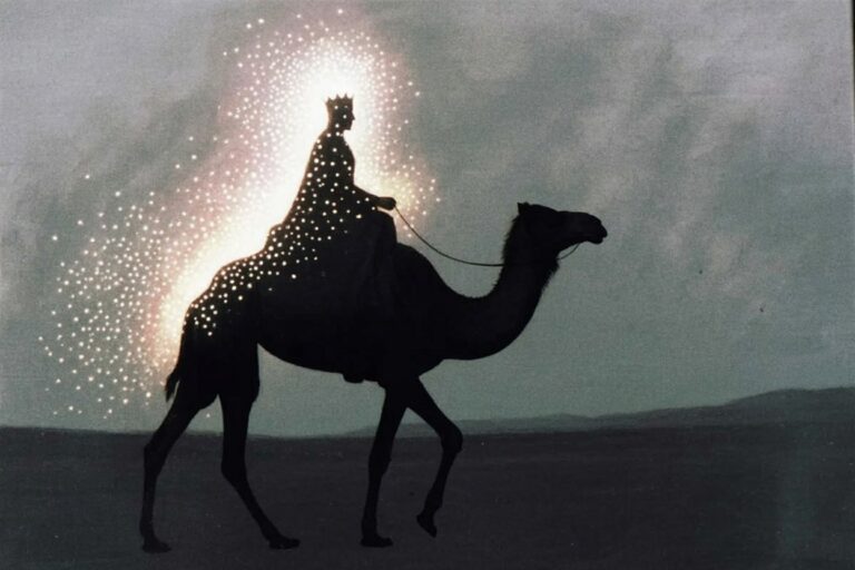 Black silhouette of crowned figure riding camel in profile against misty gray background with sparkling white light around crown and rolling hills in distance
